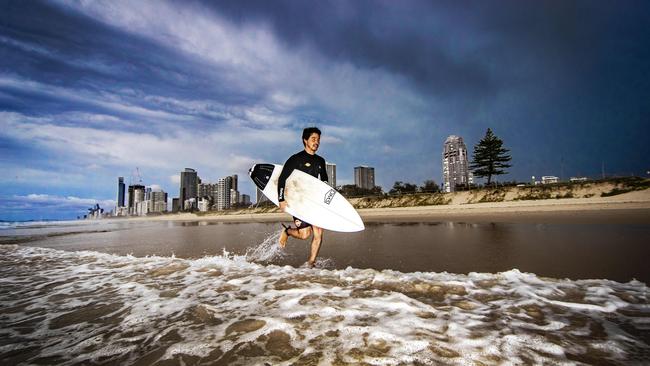 Loui Shiraseu from Southport surfing at Main Beach as a storm builds overhead. Picture: Nigel Hallett