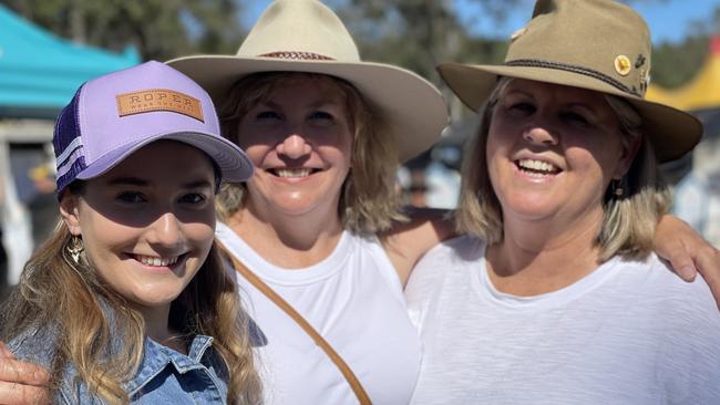 Amber Riethmuller, Cindy Riethmuller and Ceri Harbison, from Brisbane and the Sunshine Coast, enjoy day one of the 2024 Gympie Muster, at the Amamoor State Forest on August 22, 2024.