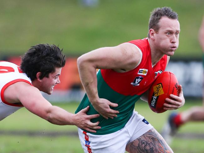 Karingal v Pines. Pines' Adam Marriner breaks through the tackling attempt of Karingal's Broguen Roberts. PIC: David Trend. Weekly Times Footy 15 - 08/07