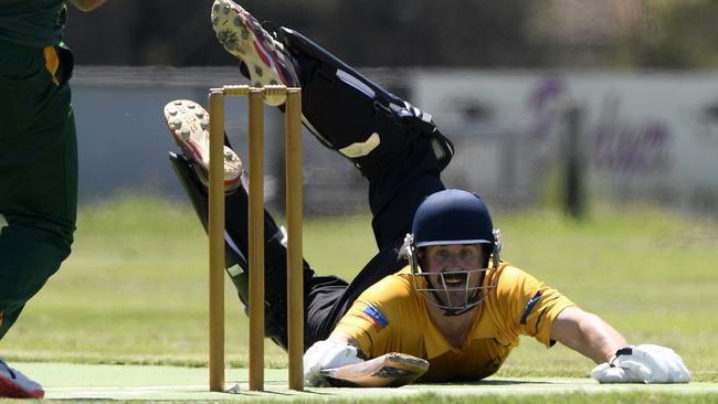 Ryan Billinghurst dives for the crease for Sunbury United. Picture: Andy Brownbill