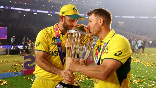 AHMEDABAD, INDIA - NOVEMBER 19: Glenn Maxwell and David Warner of Australia poses with the ICC Men's Cricket World Cup Trophy following the ICC Men's Cricket World Cup India 2023 Final between India and Australia at Narendra Modi Stadium on November 19, 2023 in Ahmedabad, India. (Photo by Robert Cianflone/Getty Images)