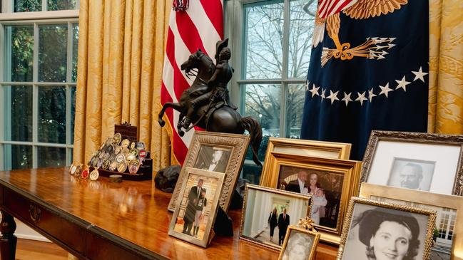 Photos of President Trump and his family members grace a small table near the Resolute Desk. Picture: WSJ