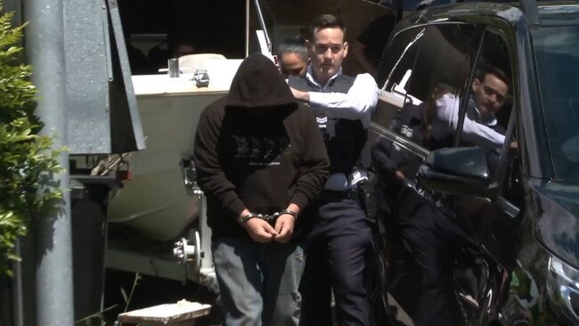 A 27-year-old from Seaforth, is arrested by Australian Federal Police attached to Operation Arkstone. Picture: AFP