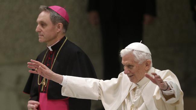 Pope Benedict XVI is flanked by Archbishop Georg Ganswein during a weekly general audience at The Vatican in 2013. Picture: AP