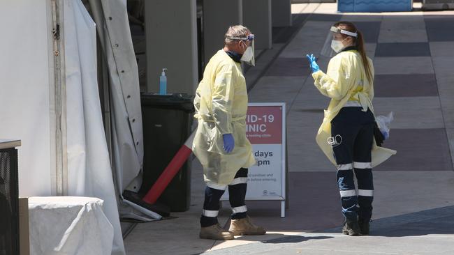 Health workers in full PPE at the Covid walk-in testing clinic in January. Picture: NCA NewsWire / Emma Brasier