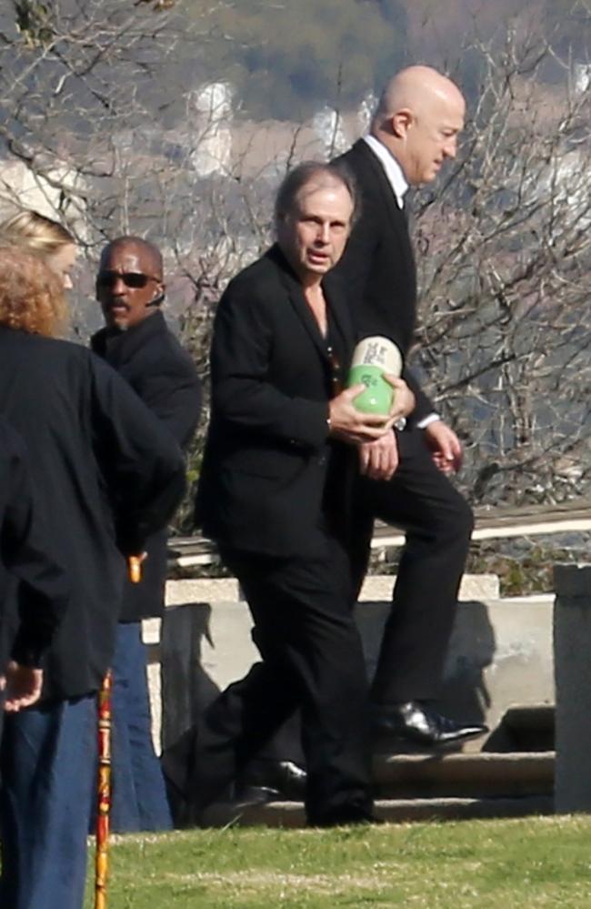 Todd Fisher, carrying the oversized Prozac pill, leads the mourners at Forest Lawn Drive for the twin burials of Carrie Fisher and Debbie Reynolds. Picture: Clint Brewer / Splash News