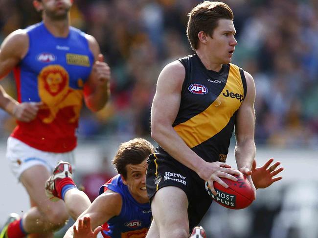 AFL Round 20. Richmond v Brisbane at the MCG.Matt White leaves a diving Jed Adcock in his wake as he runs forward and kicks a goal during the 2nd quarter. Saturday August 10, 2013. Melbourne, Australia.