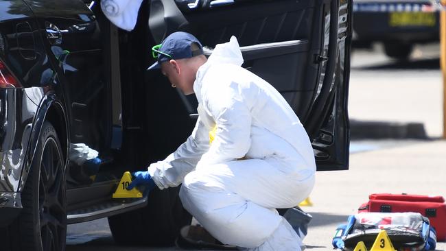 Police forensics examine the car Hawi was shot in. Picture: AAP Image/David Moir