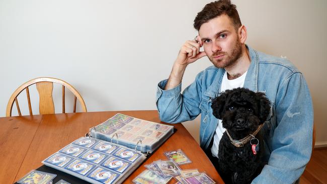 Elliot Weston and his dog Miso. Mr Weston is chasing money he paid Collect Em All Pty Ltd for Evolving Skies Pokemon card sets. Picture: Ian Currie