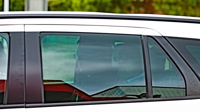 Prime Minister Scott Morrison and his security detail board a plane on the tarmac after a car carrying his security roll in Tasmania. Picture: Jason Edwards