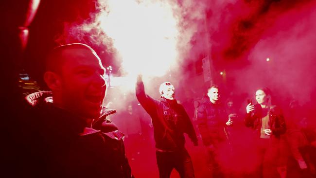 Protesters light flares during the rally. Picture: AFP