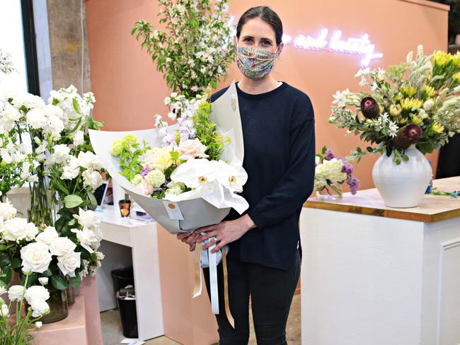 Sophie Geisser of Eden and Bell on Crown st Surry Hills holding one of the many buches of flowers ready to go out to clients on Freedom day. Picture: NCA NewsWire / Adam Yip