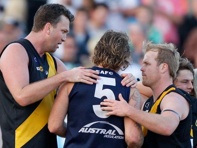 Seaford's Daniel Clarke (left) and Chris Fortnam (right) console Edithvale-Aspendale coach and former Frankston VFL teammate John Hynes after the 2009 MPNFL Peninsula grand final. Fortnam is playing superules with the Frankston Tigersharks.