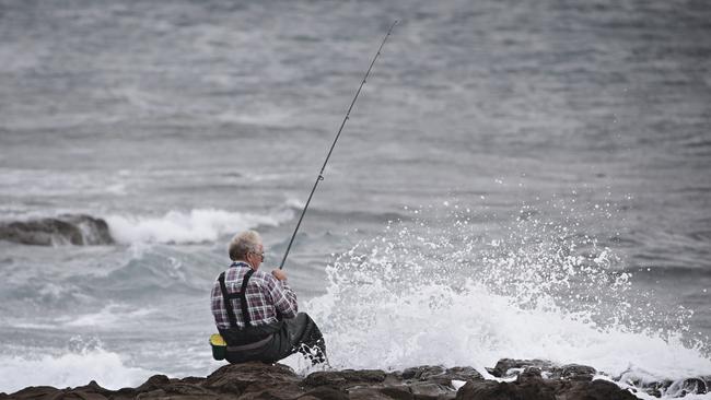 A fisherman at the popular fishing spot following the drownings. Picture: Adam Yip