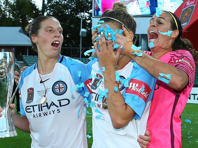 Lydia Williams (right) pranks Steph Catley (centre), with Rebekah Stott watching on after Melbourne City won the 2017 W-League grand final. Picture: Getty