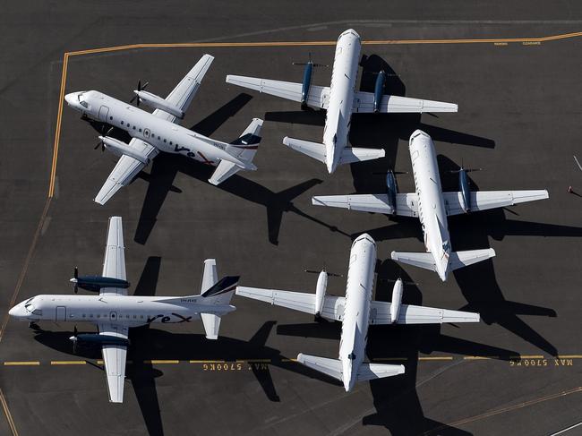 SYDNEY, AUSTRALIA - APRIL 22: An aerial view of Rex Airlines aircraft at Sydney Airport on April 22, 2020 in Sydney, Australia. Restrictions have been placed on all non-essential business and strict social distancing rules are in place across Australia in response to the COVID-19 pandemic.  (Photo by Ryan Pierse/Getty Images)