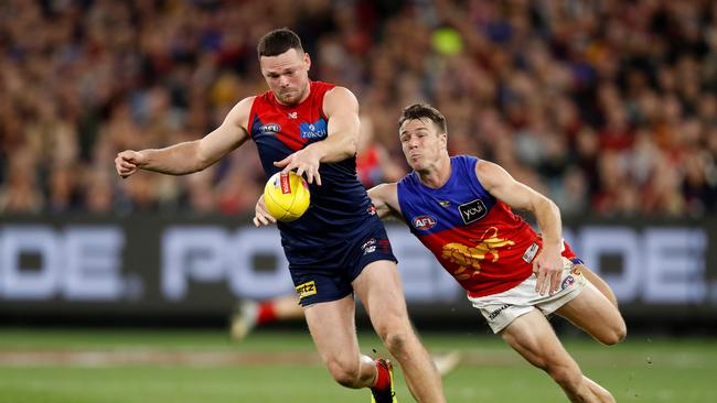 Steven May gets a kick away in front of Lion Lincoln McCarthy. Picture: Dylan Burns/AFL Photos