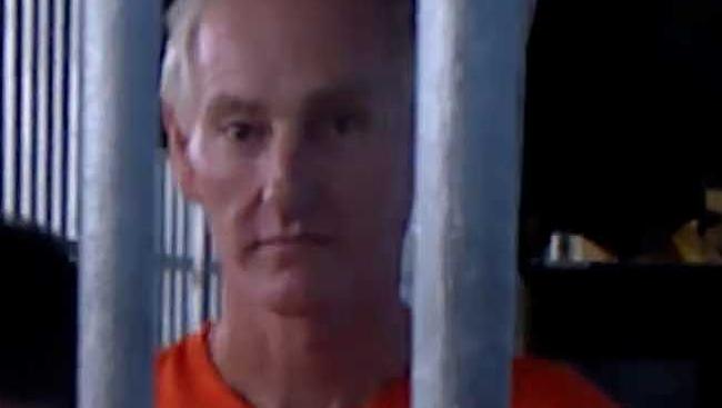 Accused paedophile Peter Scully behind bars.