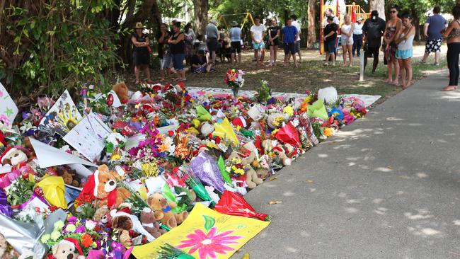 A growing sea of gloral tributes and plush toys at the makeshift memorial in a park near the house where eight children were killed. Pic: Brendan Radke.