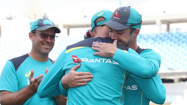 Travis Head of Australia receives his Baggy Green cap from Nathan Lyon.