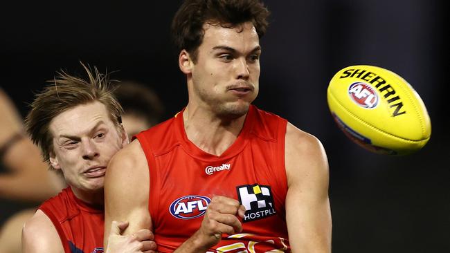 AFL Round 20. Gold Coast Suns v Melbourne at Marvel Stadium, Melbourne. 01/08/2021.  Jack Bowes of the Suns clears as he is tackled by Charlie Spargo of the Demons during the 1st qtr.     .  Pic: Michael Klein