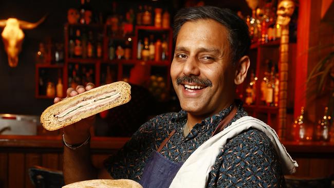 Sydney CBD bar owner Micky Dhinse with Papa Gedes famous sandwich, the Muffuleta. Picture: Richard Dobson