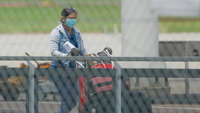 One of the travellers from Australia’s first group of international arrivals to be forced into hotel quarantine leaves the plane from Dili after it landed in Darwin 14 days ago ... the travellers will be released from their Darwin hotel quarantine today. Picture: Glenn Campbell