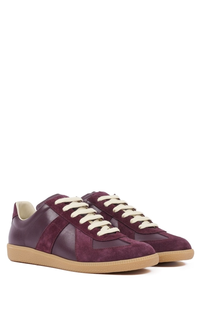 <h3><strong><a href="https://www.farfetch.com/au/shopping/men/maison-margiela/items.aspx" target="_blank" rel="noopener">Maison Margiela</a></strong></h3><p><strong>Replica sneakers</strong></p><p>This slim, low-top sneaker from Maison Margiela comes in a dark burgundy, great for introducing a subtle pop of colour to an otherwise understated outfit.</p><p><strong>Material:</strong> Suede and buffed leather | <strong>Colour range:</strong> Dark red&nbsp;| <strong>Type:</strong> Low-top sneaker | <strong>Delivery:</strong> Free shipping over $300</p><p class="button-common"><a title="SHOP NOW FOR $835" href="https://www.farfetch.com/au/shopping/men/maison-margiela-replica-leather-sneakers-item-21999120.aspx" target="_blank" data-cta="SHOP NOW FOR $835" data-editable="true">SHOP NOW FOR $835</a></p>