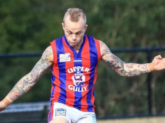 Upper Ferntree Gully footballer Jordan Whiteman gets the ball on his boot. Picture: Davis Harrigan