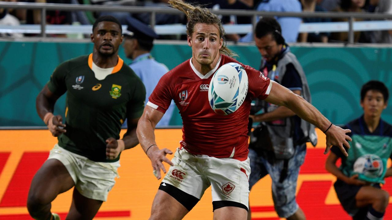 Canada's wing Jeff Hassler (R) runs for the ball during the Japan 2019 Rugby World Cup Pool B match between South Africa and Canada at the Kobe Misaki Stadium in Kobe on October 8, 2019. (Photo by Filippo MONTEFORTE / AFP)