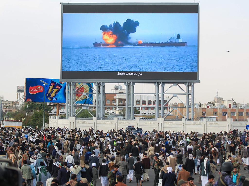 Images of a fireball exploding on a cargo ship are shown on a giant screen during a protest called for by Yemen's rebel Houthi movement in Sanaa. Picture: AFP