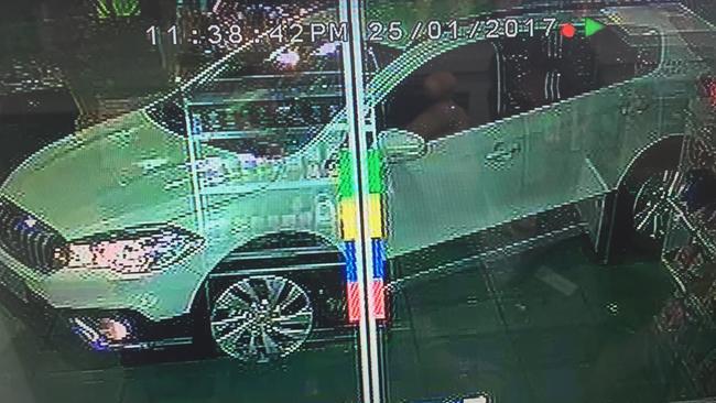 The stolen white SUV captured on camera at a BP service station.