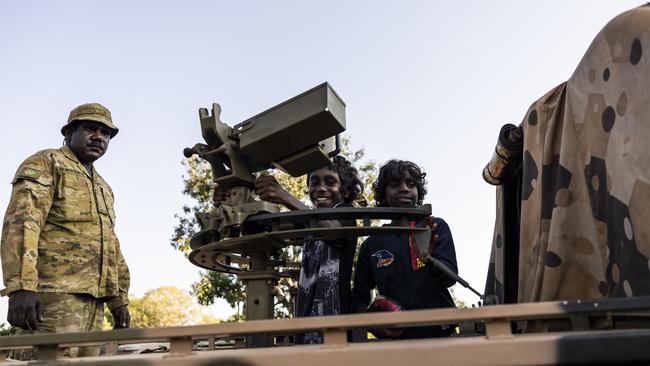 Private Peter Puruntatameri watches as local children play on one of the vehicles in Wudikapildyerr. Picture: Dylan Robinson