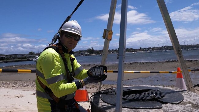 Sydney Water worker installing an IoT sensor.