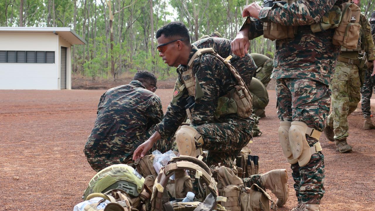 Timorese soldiers prepare their kit before the shoot.