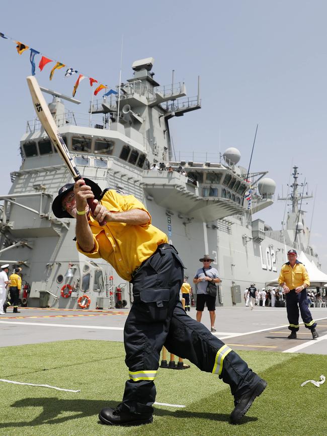 Navy, Army and RFS volunteers play cricket aboard HMAS Canberra. Picture: Nikki Short