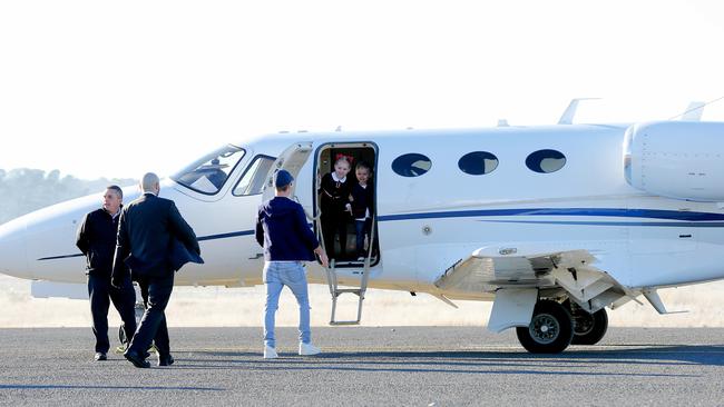 Oliver Curtis greets his children in Cooma after a year “away on business”. Picture: Stephen Cooper