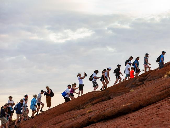 Climbers heading up Uluru in Uluru-Kata Tjuta National Park on one of the last days before the climb closes on 26 October.+++Caution+++ It emerged after these images were taken that there is a rule prohibiting the publication of images taken â€œup the Uluru climbâ€â€”not withstanding the fact that virtually every iPhone-wielding climber took the same images we did. A media spokesman subsequently advised that images of â€œcrowds at the base of the climbâ€ ought to be fine but that pictures showing â€œthe chain and higherâ€ might offend Anangu custodians and be considered in breach of park rules. These pictures have been filed in keeping with the good old News Corp policy of â€˜shoot first and deal with the grumpy guy laterâ€™. Please DO NOT USE PHOTOGRAPHERâ€™S BYLINE if publishing any images that might cause upset. If in doubt, seek further advice before proceeding +++ end +++