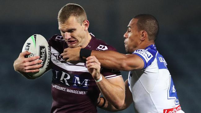 Tom Trbojevic of the Sea Eagles is tackled by Will Hopoate.