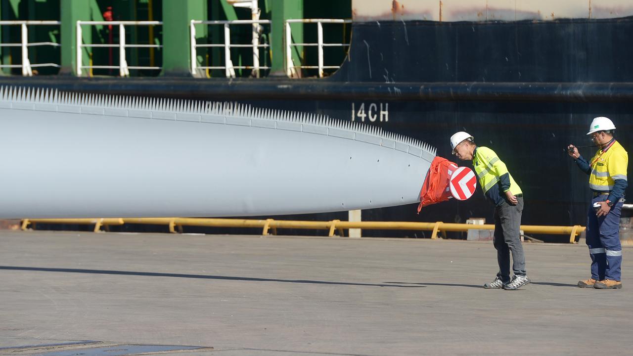 Port of Townsville workers inspect a 70 metre wind turbine blades, bound for Hughenden.