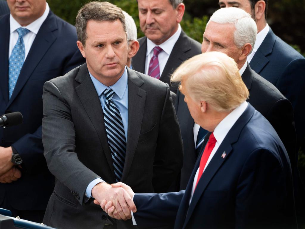 Walmart CEO Doug McMillon shakes hands with President Trump in 2020. Picture: Jim Watson / AFP