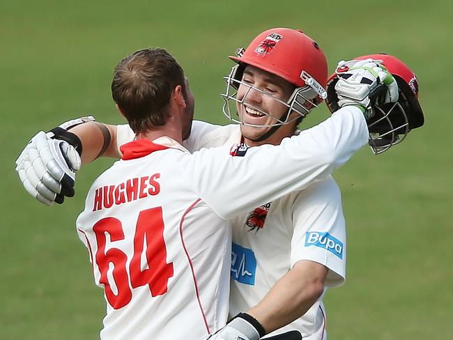 Phillip Hughes ande Travis Head embrace after Hughes hit 200 runs during a Sheffield Shield match in November, 2013. Picture: Getty Images