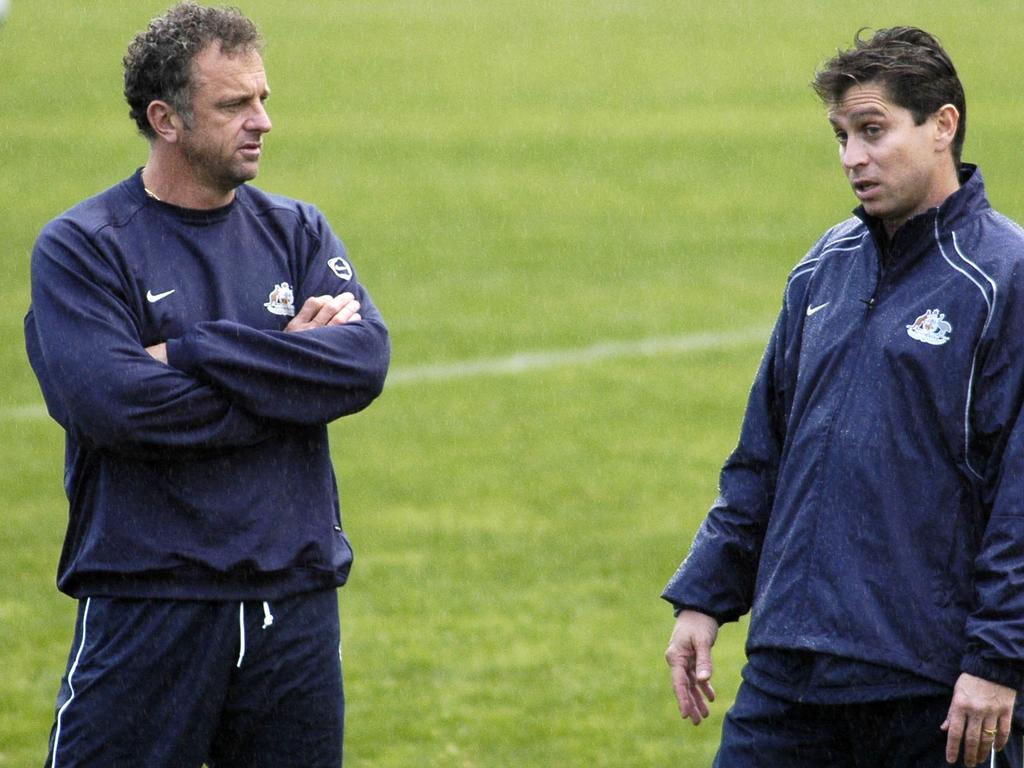 Graham Arnold (left) and Frank Farina talk tactics in 2004. Picture: AAP Image/Tom Miletic