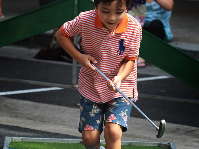 Alastair Laylo-McCall tries his hand at putt-putt golf.