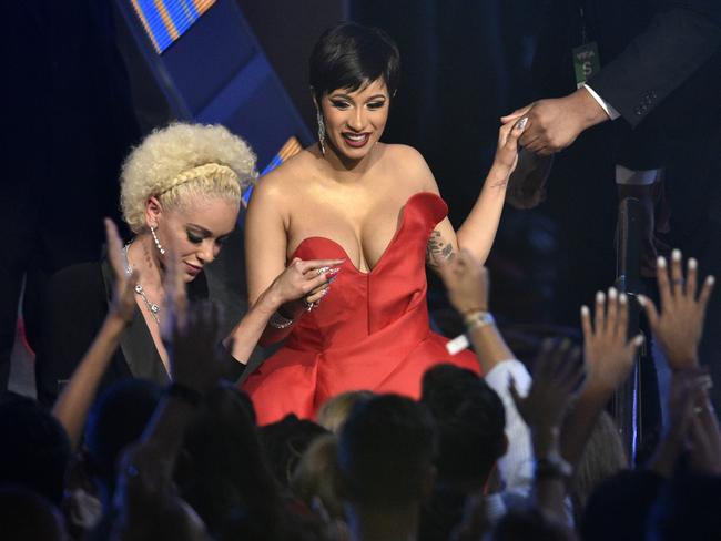 Cardi B, centre, walks in the audience to accept the award for best new artist. Picture: AP