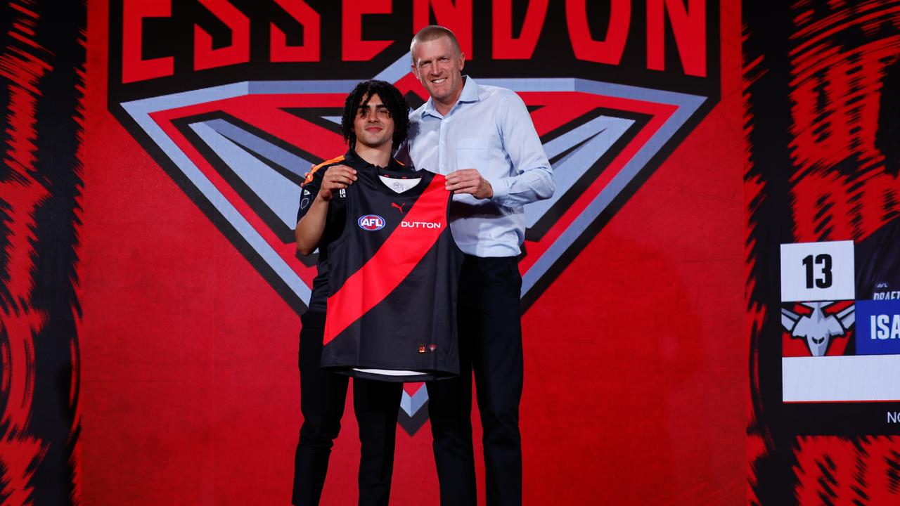 Isaac is presented with his Essendon jumper by club legend Dustin Fletcher. (Photo by Michael Willson/AFL Photos via Getty Images)