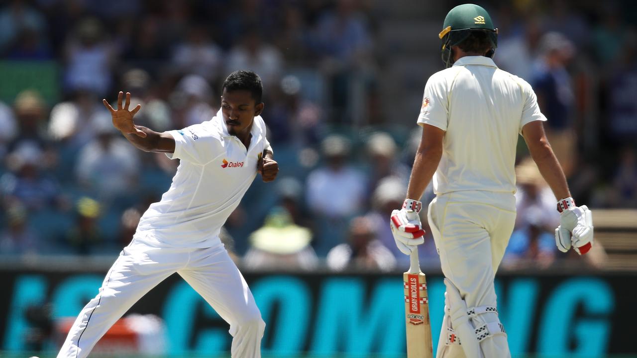 Vishwa Fernando celebrates taking the wicket of Joe Burns.  