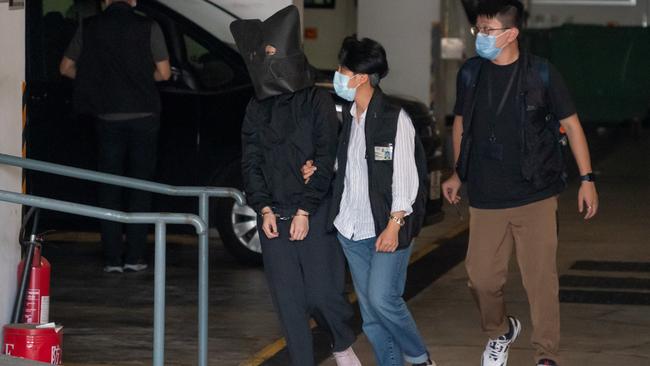 One of the five speech therapists, who were hooded and led away as police searched for evidence at an office in Hong Kong. Picture: Getty