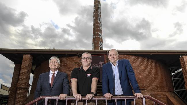 (From left) City of West Torrens Mayor Michael Coxon, West End sponsorships leader Tim Moffat and SANFL chief executive Darren Chandler stand at the new site. Picture: Roy VanDerVegt