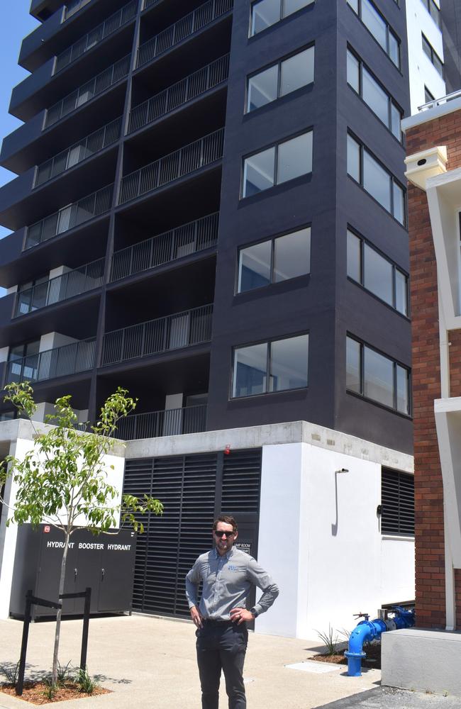 Riley Griffin in front of the newly-completed Loft apartments on Archer Street.